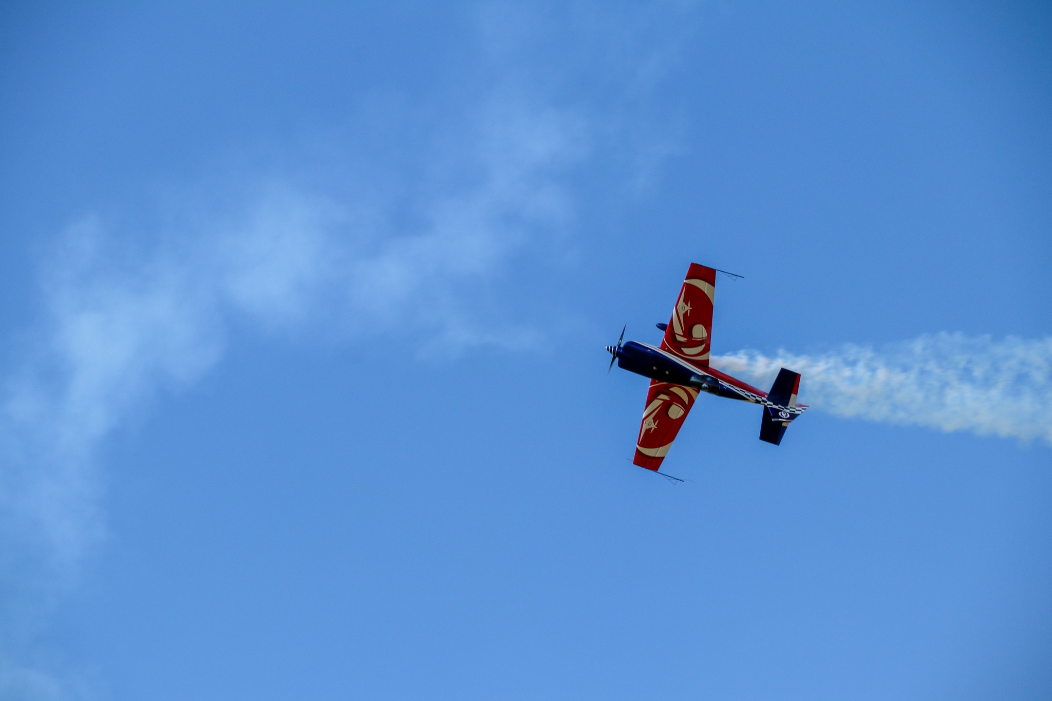 Avion rouge en voltige avec fumigène